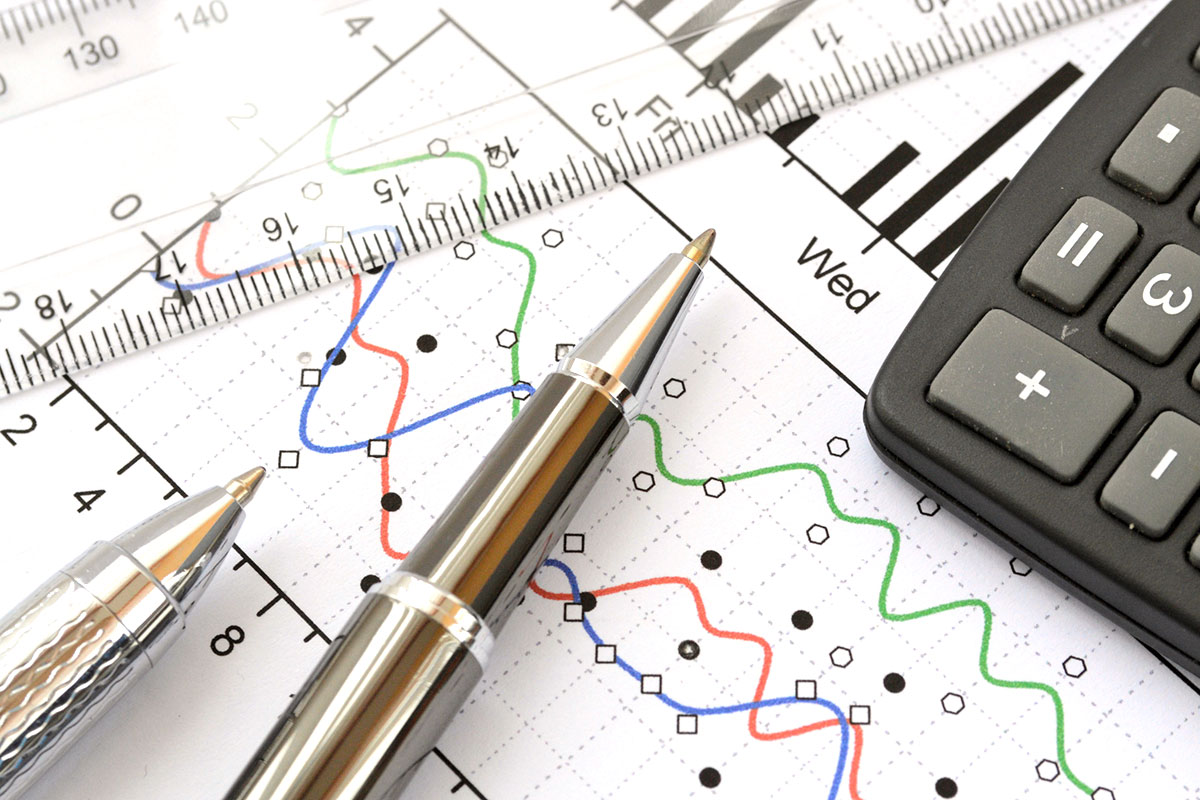 pens and ruler overlaying paper with graph data