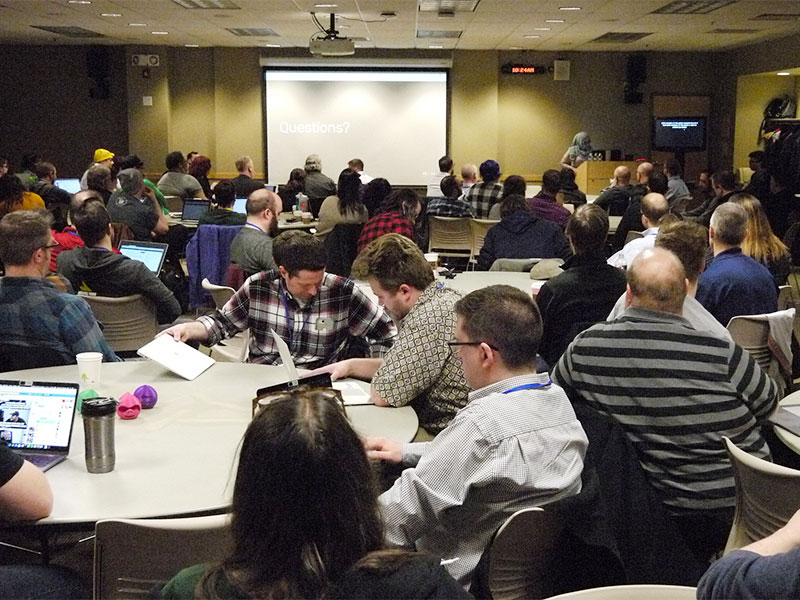 crowd of midcamp conference attendees listening to keynote talk