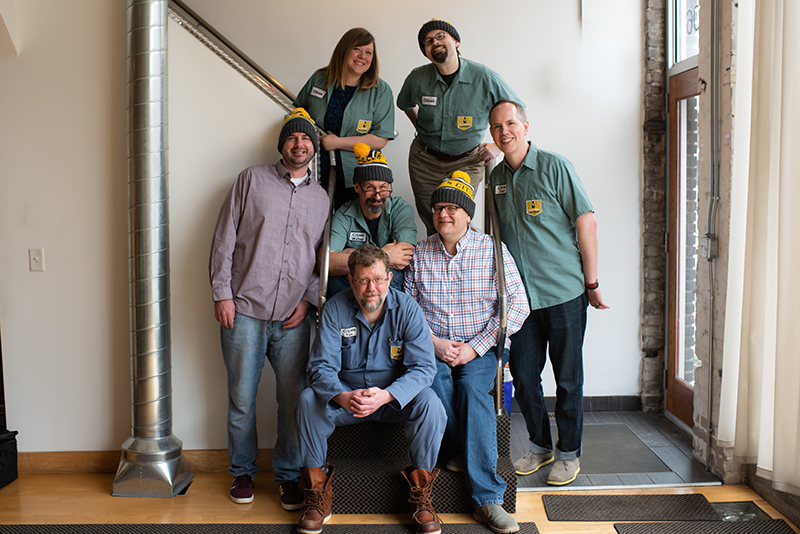 the work team posed on a stairway in the office