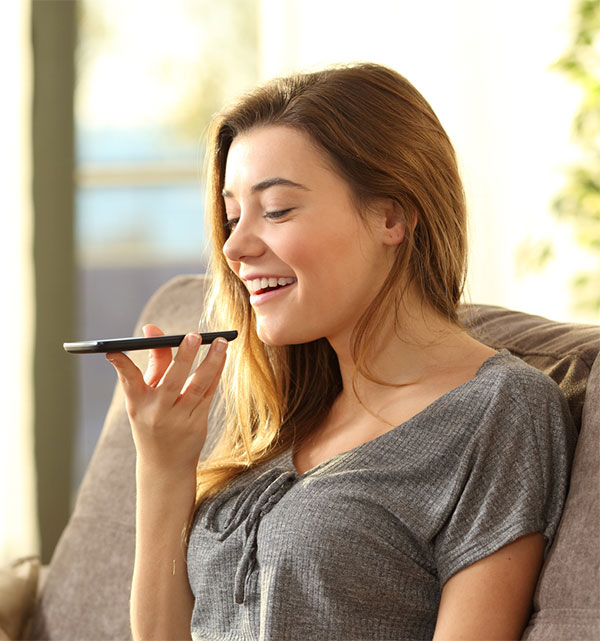 young woman using voice commands with her phone