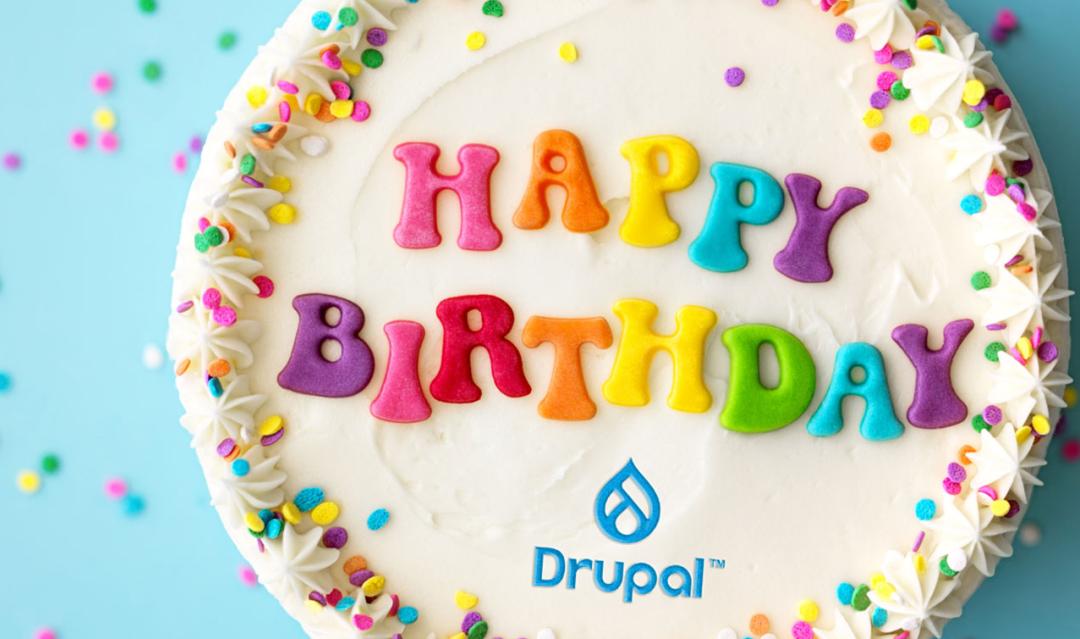 Birthday cake with "happy birthday" written on the top and a Drupal logo