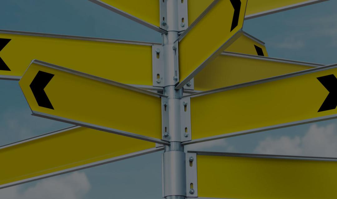 yellow directional signs pointing in multiple directions against a blue sky