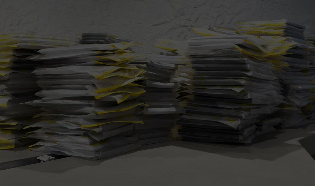 piles of papers stacked across the top of an office desk