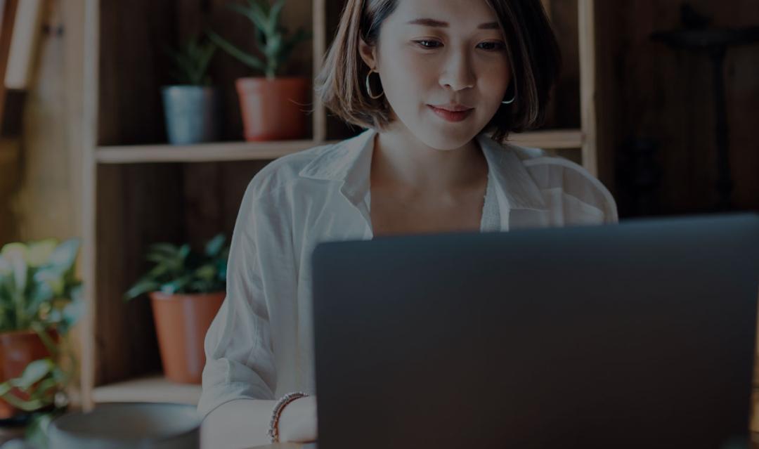 woman on laptop while at work in office