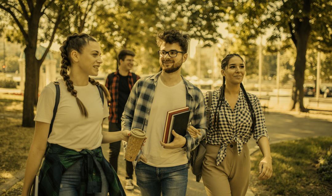 young college students walking across campus