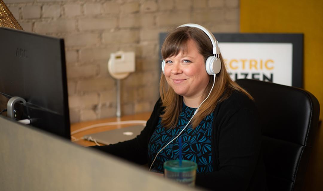 EC staff working at desk, talking with client over phone