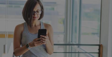 business woman at the office searching the web on her mobile phone