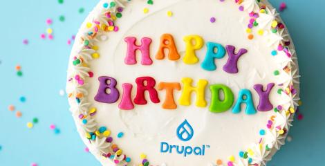 Birthday cake with "happy birthday" written on the top and a Drupal logo