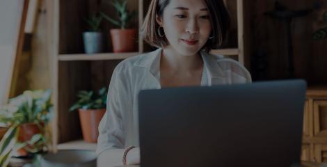 woman on laptop while at work in office