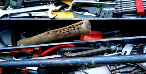 Toolbox top shelf filled with used tools.