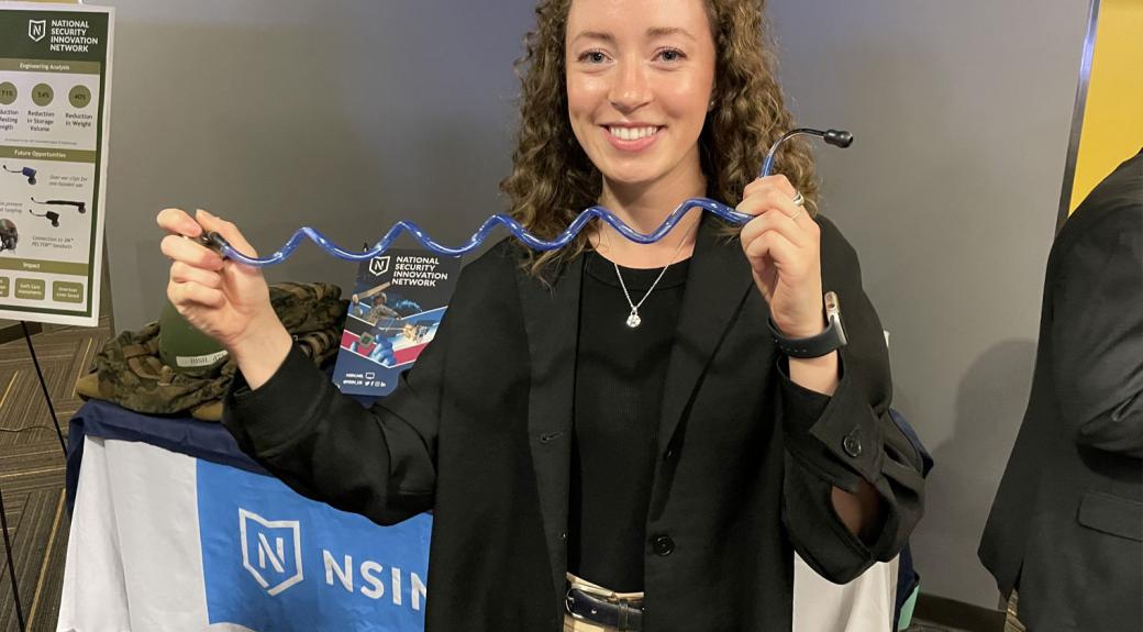 college student displaying their science work