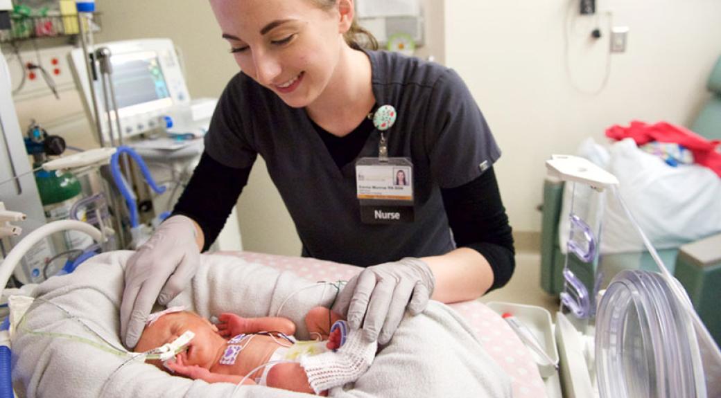 nurse caring for a newborn baby in hospital