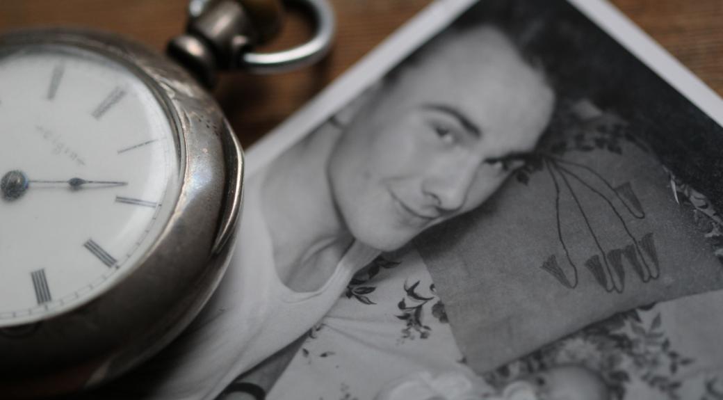 Pocket watch and old photograph of mother and child