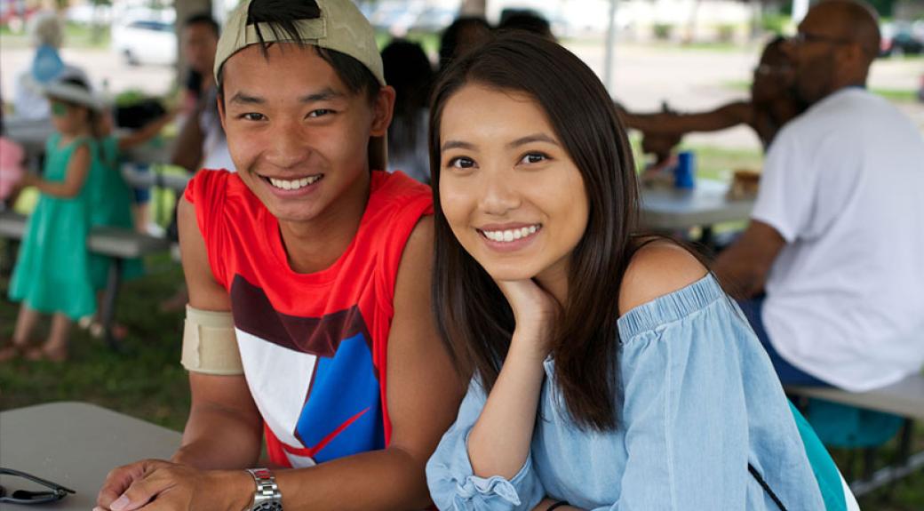 young adult asian american couple at an outdoor picnic