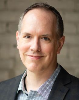 photo of Dan Moriarty wearing dress shirt and jacket