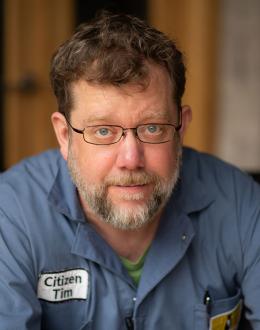 photo of Tim Broeker wearing his Electric Citizen blue jumpsuit