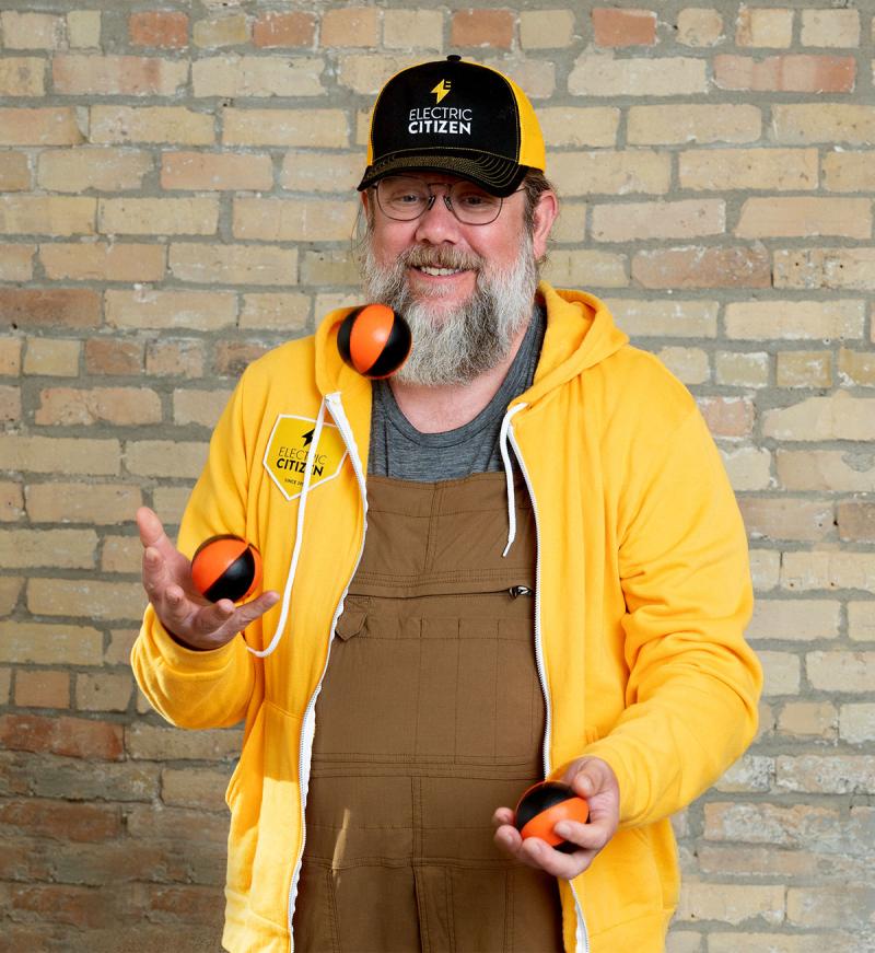 Tim juggling balls while wearing EC gold apparel