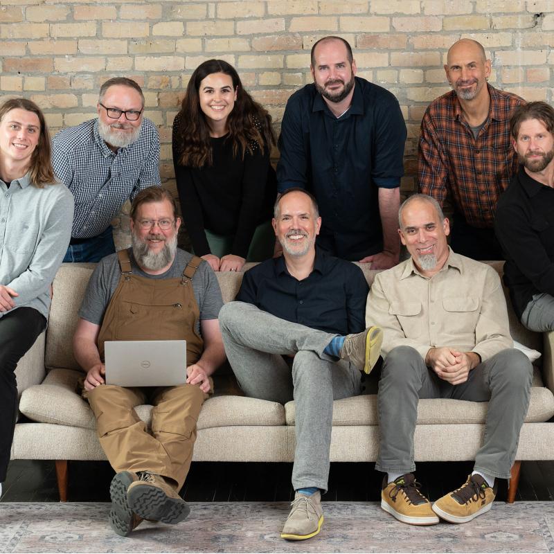 Electric Citizen team together around a couch
