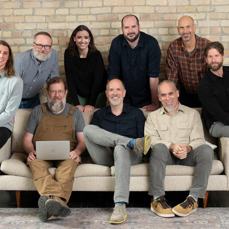 some members of the team gathered around a couch