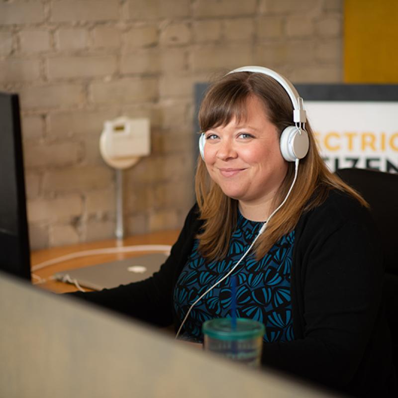 EC staff working at desk, talking with client over phone