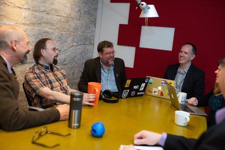 a team talking and laughing in a conference room