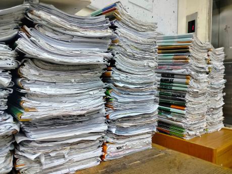 piles of books stacked together on a table