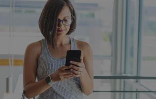 business woman at the office searching the web on her mobile phone
