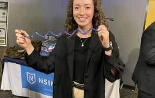 college student displaying their science work