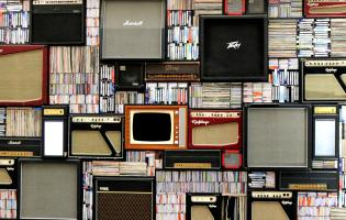 Bookshelf with vintage books, speakers and tvs