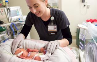 nurse caring for a newborn baby in hospital