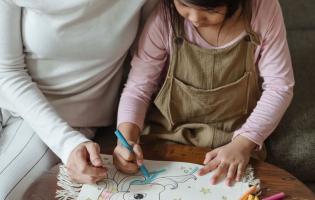 mother and daughter drawing together