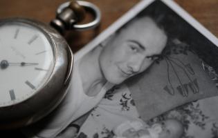 Pocket watch and old photograph of mother and child
