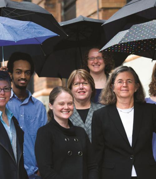 staff of legal state support, outside with umbrellas in their hands