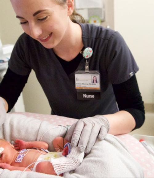 nurse caring for a newborn baby in hospital