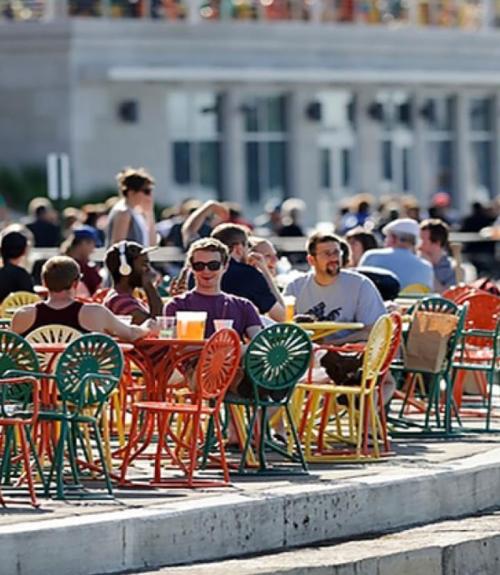 people sitting at tables outside of the Wisconsin Union 