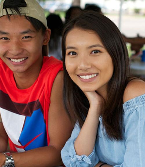 young adult asian american couple at an outdoor picnic
