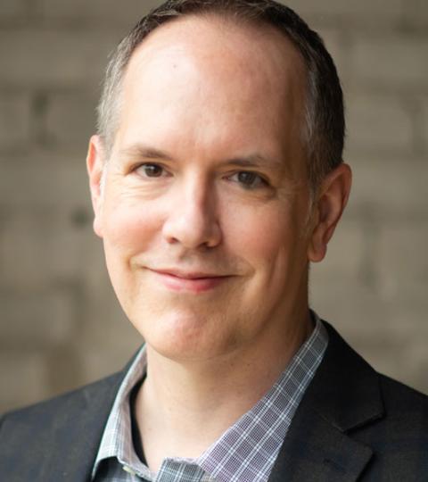 photo of Dan Moriarty wearing dress shirt and jacket
