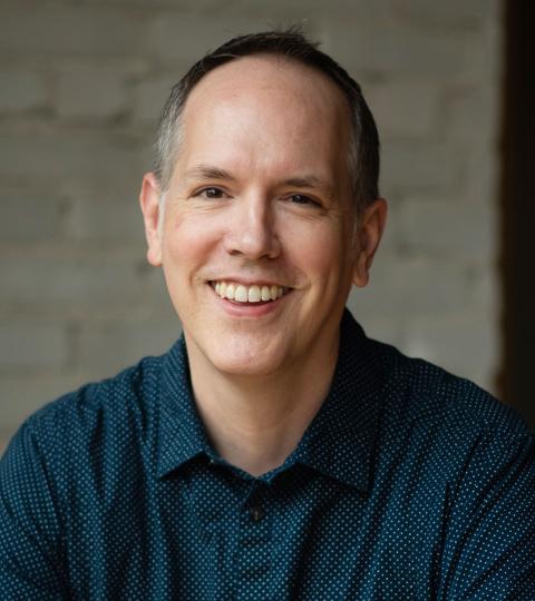 photo of Dan Moriarty wearing a dark blue dress shirt