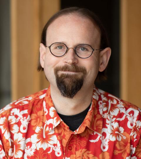 photo of Oz Heller wearing a red printed shirt